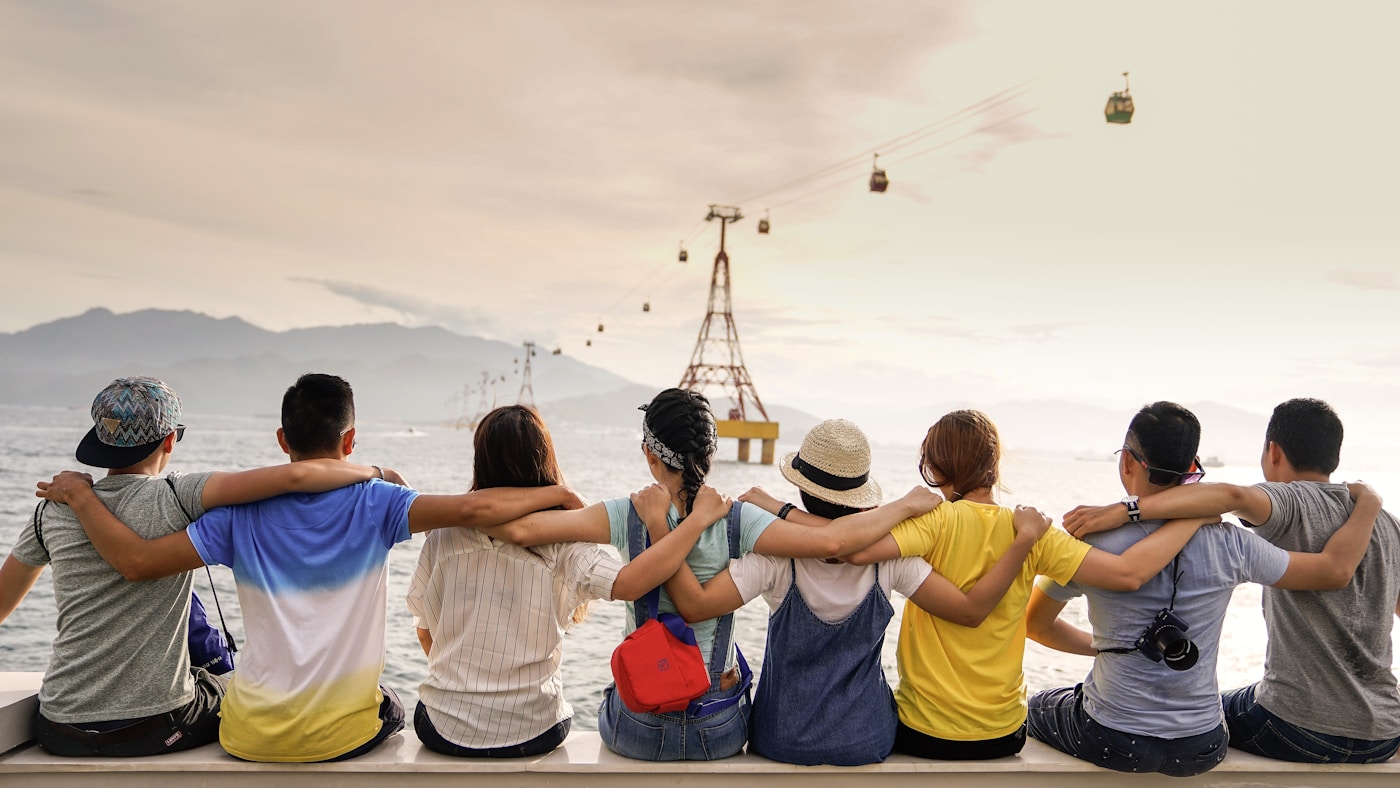 A diverse group of friends spending time together by the water