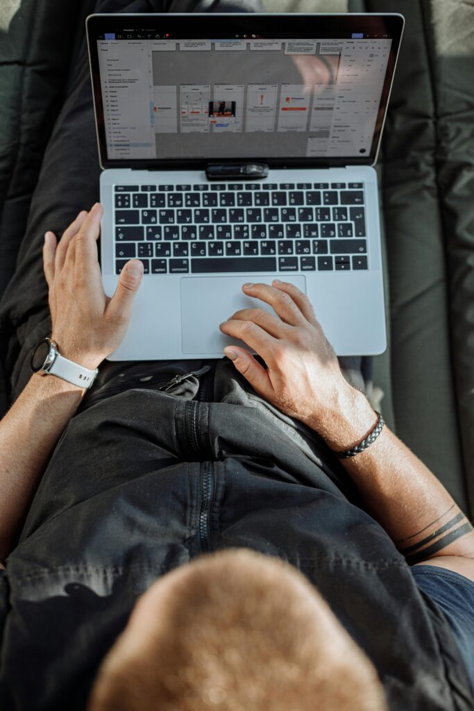 Professional working on a laptop from a home office, viewed from above, representing focused and modern computer-based work